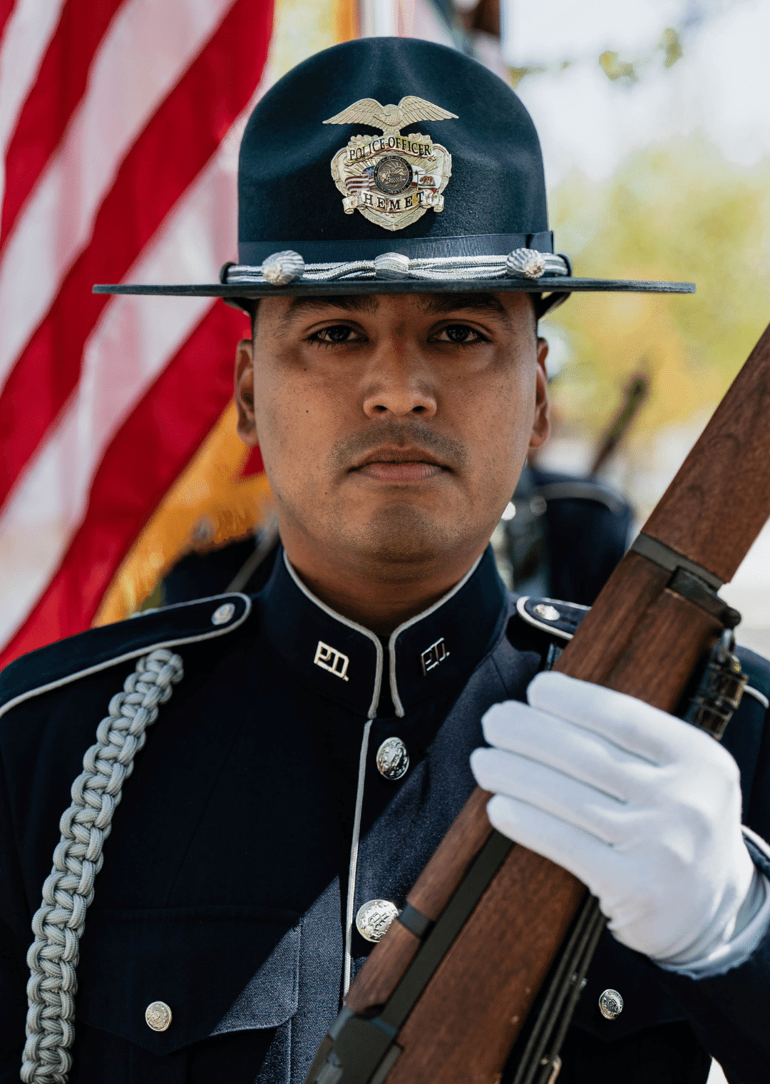 A Hemet Police. Honor Guard member holds a ceremonial rifle across his chest