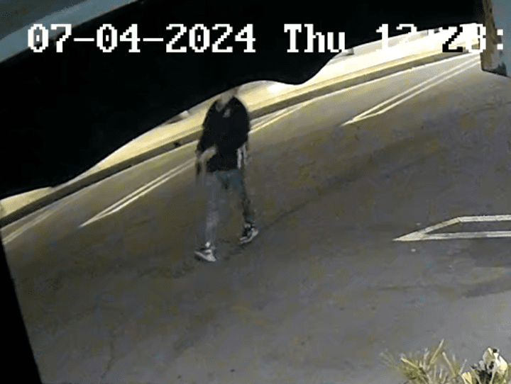 The subject walking away from a local bar holding the pistol.